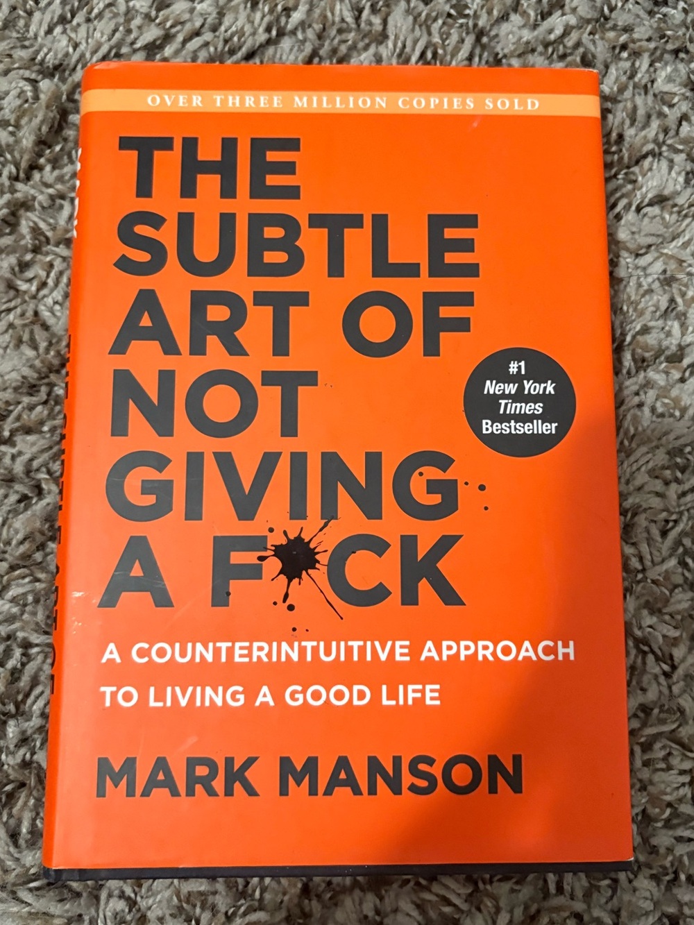The Subtle Art of Not Giving a F*ck by Mark Manson - Bright Orange Hard Cover